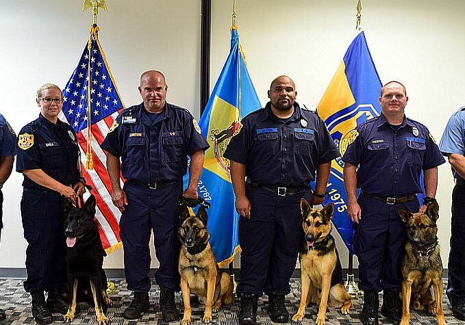 L-R:  K9 Trainer Educator III Mark Bower, Sergeant Nicole Sroka and K9 Drago, Officer Aaron Lankford and K9 Knox, Officer Garrett Taylor and K9 Sirius, Officer Scott Bollinger and K9 Prince, K9 Trainer Educator I Ryan Walker