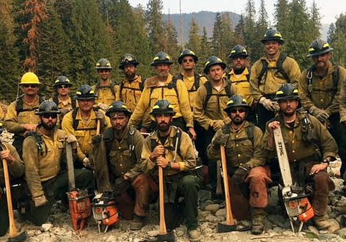 Delaware's wildfire after completing their final shift on Division Alpha of the Cougar Fire. The crew are shown on the banks of Lightning Creek in Idaho