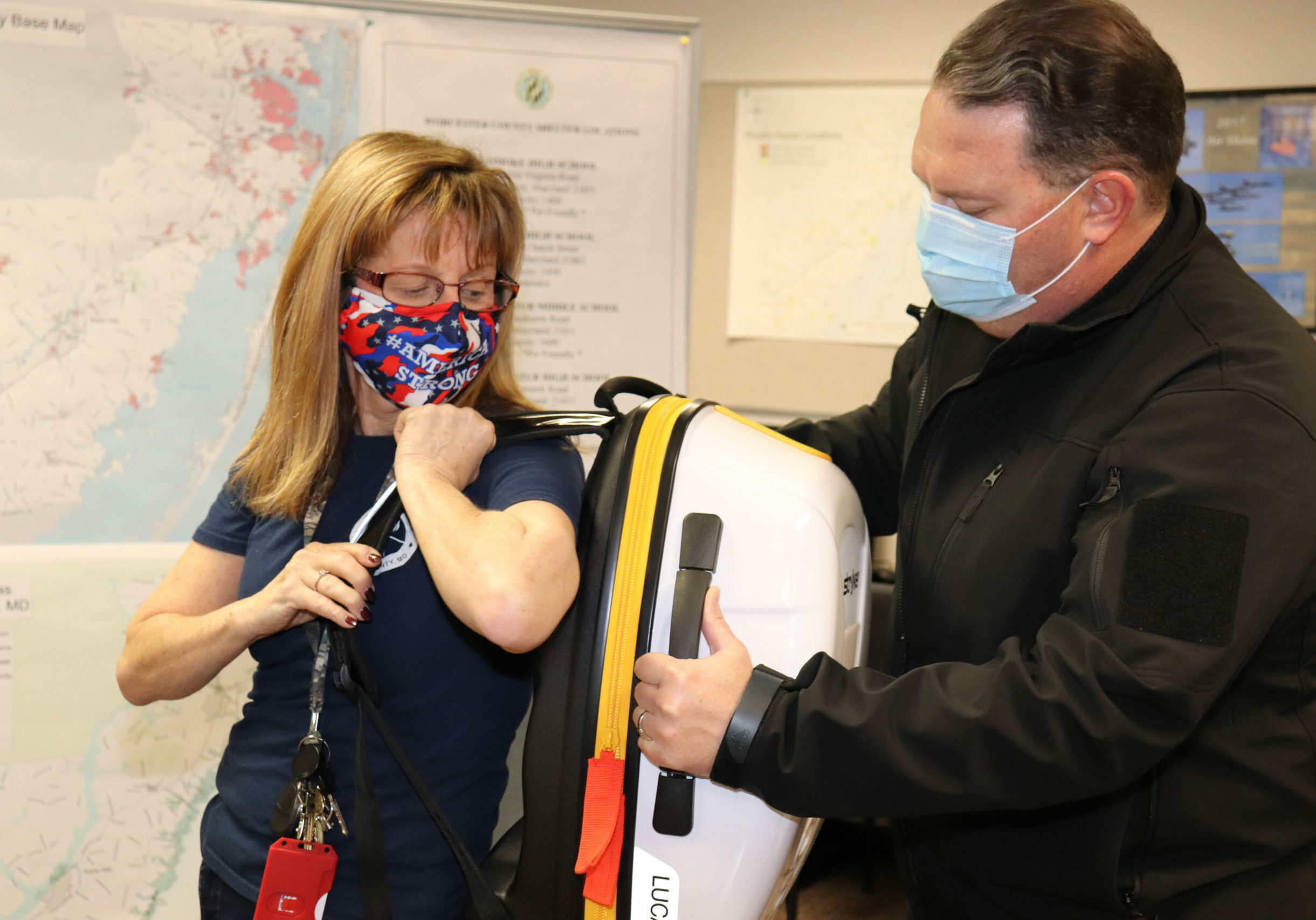 Worcester County Emergency Services (WCES) Planner Laraine Buck (left) and Director Billy Birch demonstrate the portability of a LUCAS hands-free mechanical CPR devise. WCES utilized approximately $168,000 in CARES Act funds to purchase nine LUCAS units for nine volunteer fire companies in Worcester County and to reimburse another volunteer fire company for the cost of one unit purchased independently.