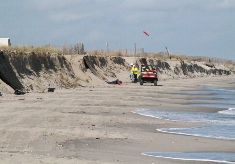 Crewmembers from Lewis Environmental, a remediation contractor, conducts cleanup operations of oil patties that washed ashore at various locations on the Delaware Bay coastline between Fowler Beach and Cape Henlopen, Delaware, Oct. 21, 2020. A unified command consisting of the United States Coast Guard and Delaware Department of Natural Resources and Environmental Control (DNREC) has been established as cleanup efforts continue. (Courtesy photo/Released)