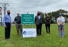 Governor Carney, Representative Pete Schwartzkopf, DelDOT Deputy Secretary Nicole Majeski, Coalition for the Delaware River Watershed State Policy Manager Kelly Knutson, and Delaware Nature Society Director of Advocacy and External Affairs Emily Knearl with the new sign